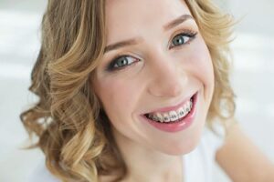 young woman learning about the connection between adults and braces 